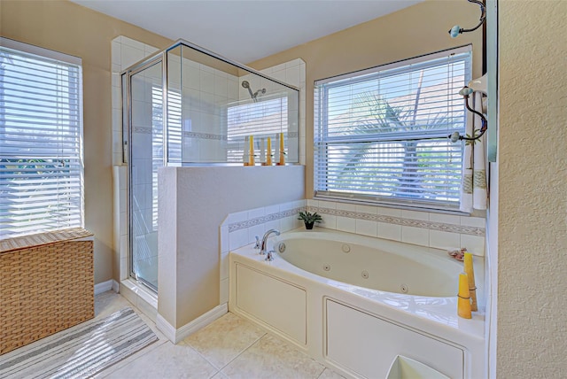 bathroom featuring plus walk in shower, tile patterned floors, and plenty of natural light