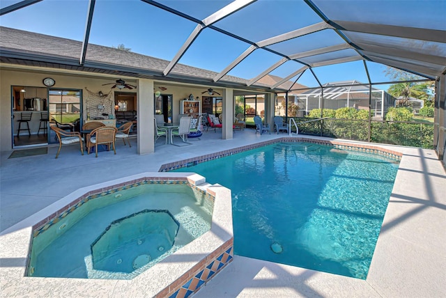 view of pool with a lanai, an in ground hot tub, a patio, and ceiling fan