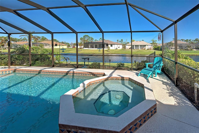 view of pool featuring an in ground hot tub, a lawn, and glass enclosure