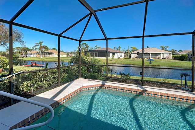 view of pool featuring a yard, a water view, and glass enclosure