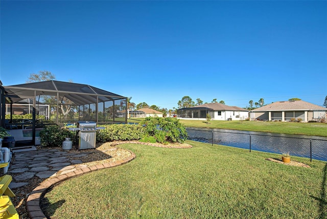 view of yard featuring a water view and a lanai