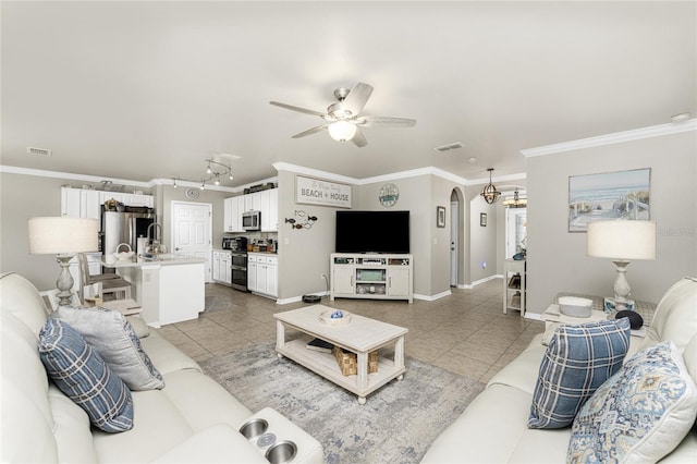 tiled living room with ornamental molding and ceiling fan with notable chandelier