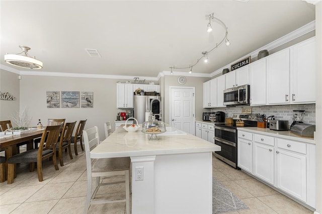 kitchen with white cabinetry, a center island with sink, and stainless steel appliances