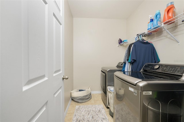 washroom with light tile patterned floors and independent washer and dryer