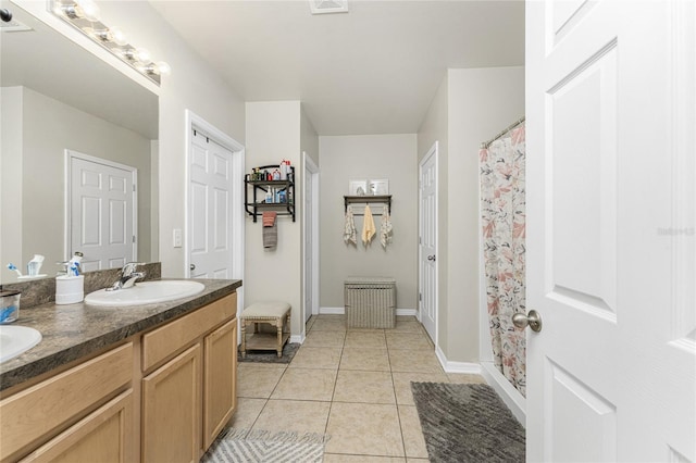 bathroom featuring walk in shower, vanity, and tile patterned floors