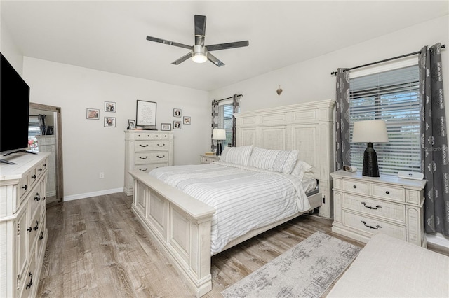 bedroom with light hardwood / wood-style floors and ceiling fan