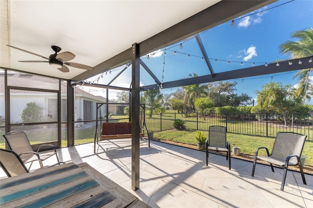 sunroom / solarium featuring ceiling fan and a healthy amount of sunlight