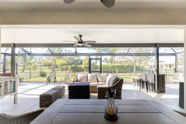 view of patio featuring a lanai, ceiling fan, and an outdoor hangout area