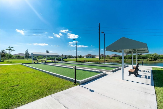 surrounding community with a lawn and a water view