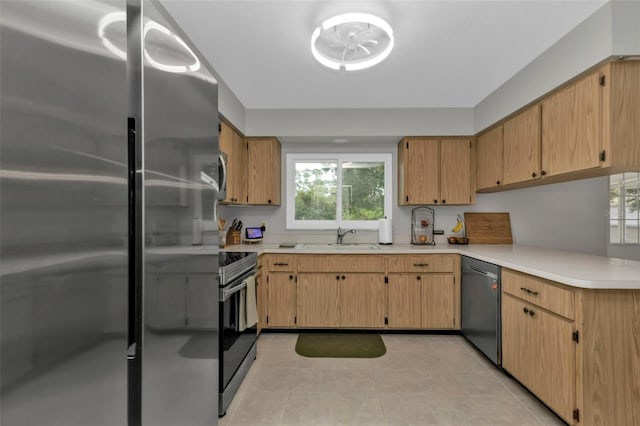 kitchen featuring light tile patterned flooring, light brown cabinetry, sink, and appliances with stainless steel finishes