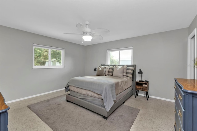 bedroom with multiple windows and ceiling fan