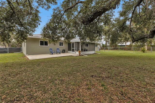 back of house with a yard and a patio area