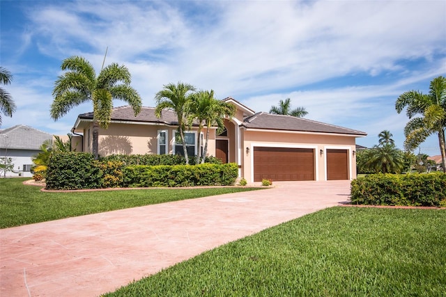 view of front of home featuring a front lawn and a garage