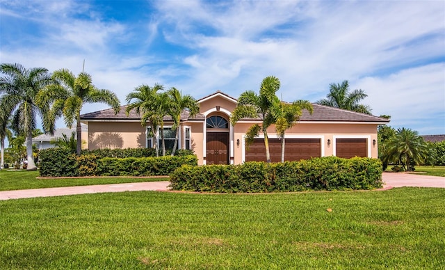 view of front facade featuring a front lawn and a garage