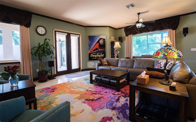 tiled living room with ornamental molding, french doors, and ceiling fan