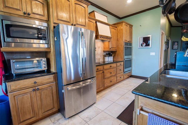 kitchen with appliances with stainless steel finishes, sink, custom exhaust hood, dark stone countertops, and crown molding