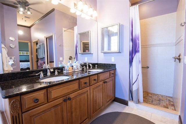 bathroom featuring ceiling fan, vanity, crown molding, a shower with curtain, and tile patterned floors