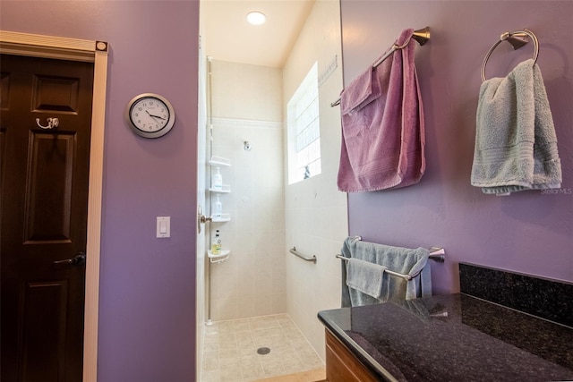 bathroom featuring a tile shower and tile patterned flooring