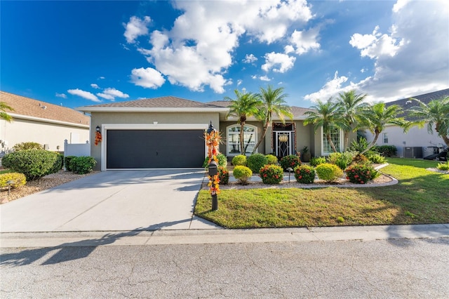 ranch-style house featuring a front yard and a garage