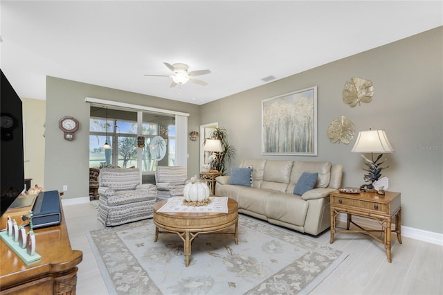 living room featuring light wood-type flooring and ceiling fan