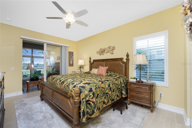 bedroom with access to exterior, multiple windows, and ceiling fan