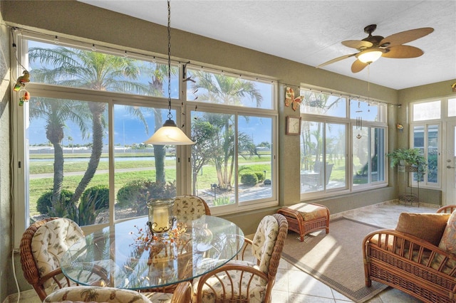 sunroom / solarium featuring ceiling fan