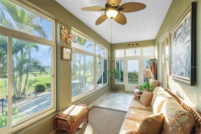 sunroom / solarium featuring ceiling fan