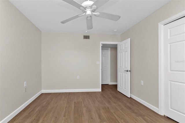 unfurnished bedroom with ceiling fan and light wood-type flooring