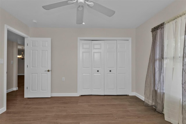 unfurnished bedroom with a closet, ceiling fan, and hardwood / wood-style floors