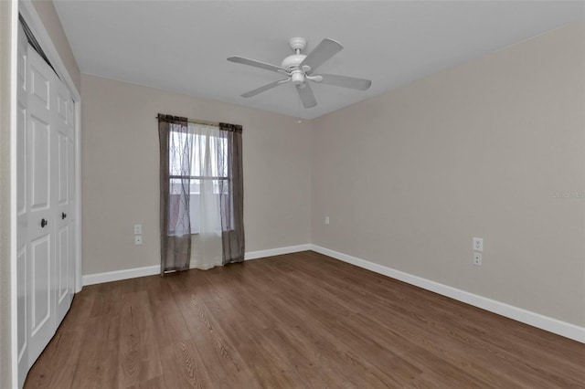 unfurnished bedroom with a closet, hardwood / wood-style floors, and ceiling fan