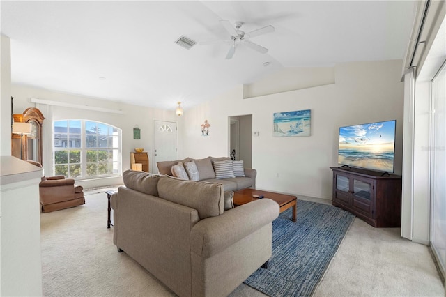 carpeted living room featuring vaulted ceiling and ceiling fan