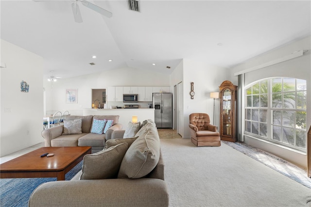 living room with light carpet, lofted ceiling, and ceiling fan