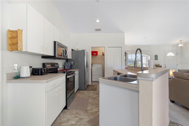 kitchen with washer / dryer, white cabinets, an island with sink, appliances with stainless steel finishes, and sink