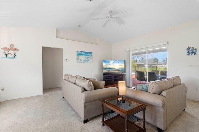 carpeted living room with ceiling fan and lofted ceiling