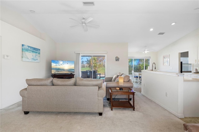 carpeted living room featuring lofted ceiling, ceiling fan, and a wealth of natural light