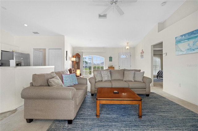 carpeted living room with ceiling fan