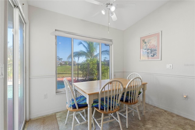 dining space featuring ceiling fan and lofted ceiling