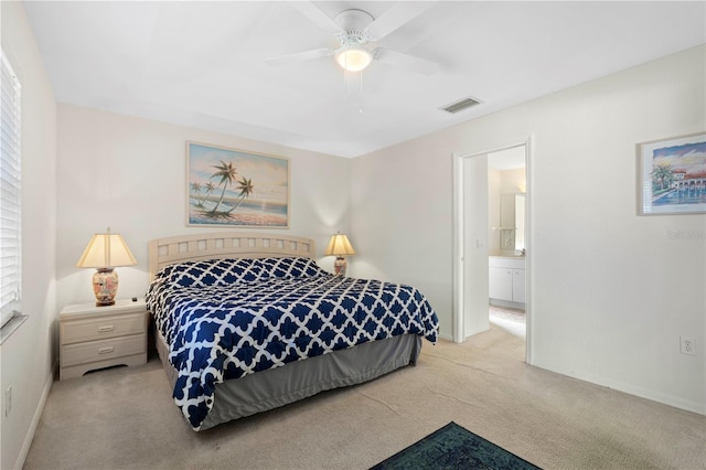 carpeted bedroom featuring connected bathroom, multiple windows, and ceiling fan