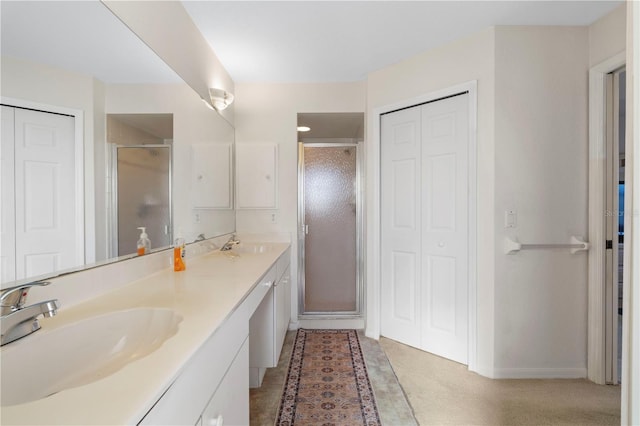 bathroom featuring a shower with door and vanity