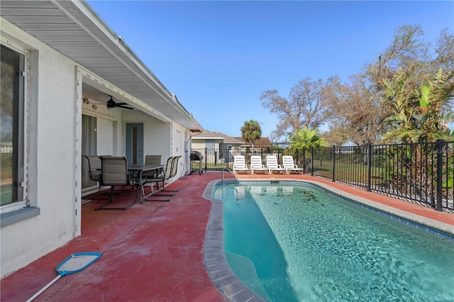 view of swimming pool with a patio area and ceiling fan