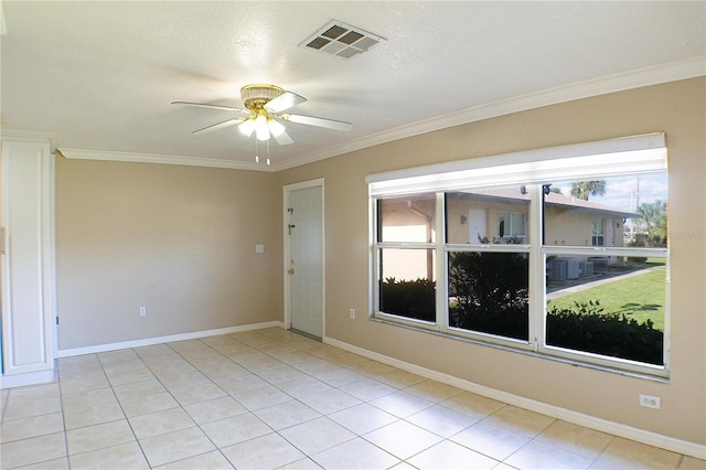 tiled empty room featuring crown molding, a textured ceiling, and ceiling fan