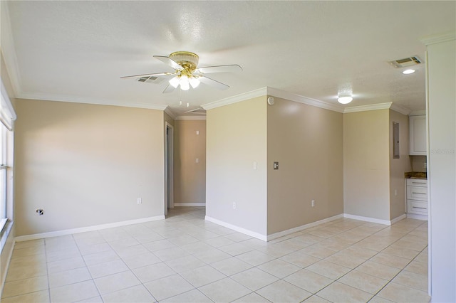 empty room featuring crown molding, light tile patterned flooring, and ceiling fan