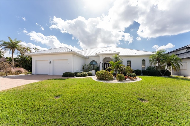 view of front of house with a garage and a front lawn