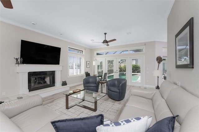 1945 Jamaica Way, Punta Gorda, FL 33950 - living area with ceiling fan, french doors, wood finished floors, a glass covered fireplace, and crown molding