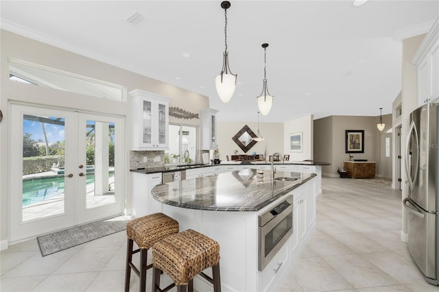 1945 Jamaica Way, Punta Gorda, FL 33950 - kitchen featuring appliances with stainless steel finishes, french doors, light tile patterned floors, glass insert cabinets, and white cabinetry