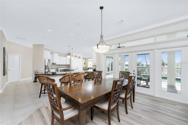 dining room featuring light wood-type flooring and french doors