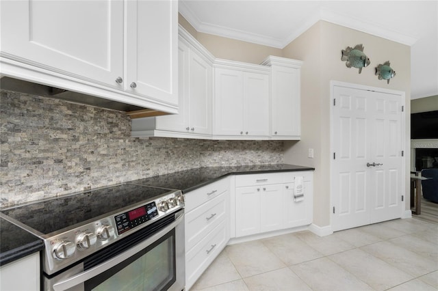 kitchen with light tile patterned flooring, white cabinetry, tasteful backsplash, stainless steel electric range, and crown molding