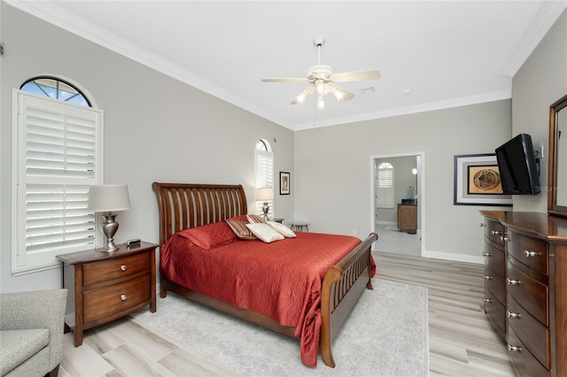 bedroom with multiple windows, ceiling fan, connected bathroom, and light hardwood / wood-style flooring