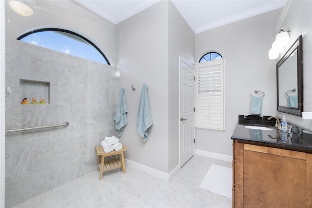 bathroom with ornamental molding, vanity, and a tile shower