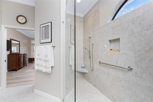 bathroom with hardwood / wood-style flooring, a tile shower, and crown molding